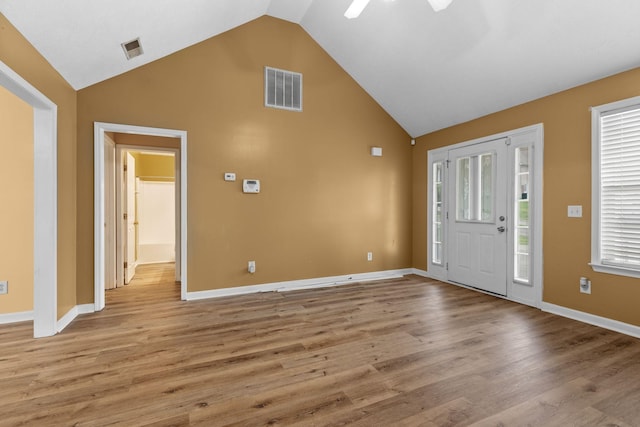 foyer with visible vents, ceiling fan, light wood-style flooring, and high vaulted ceiling
