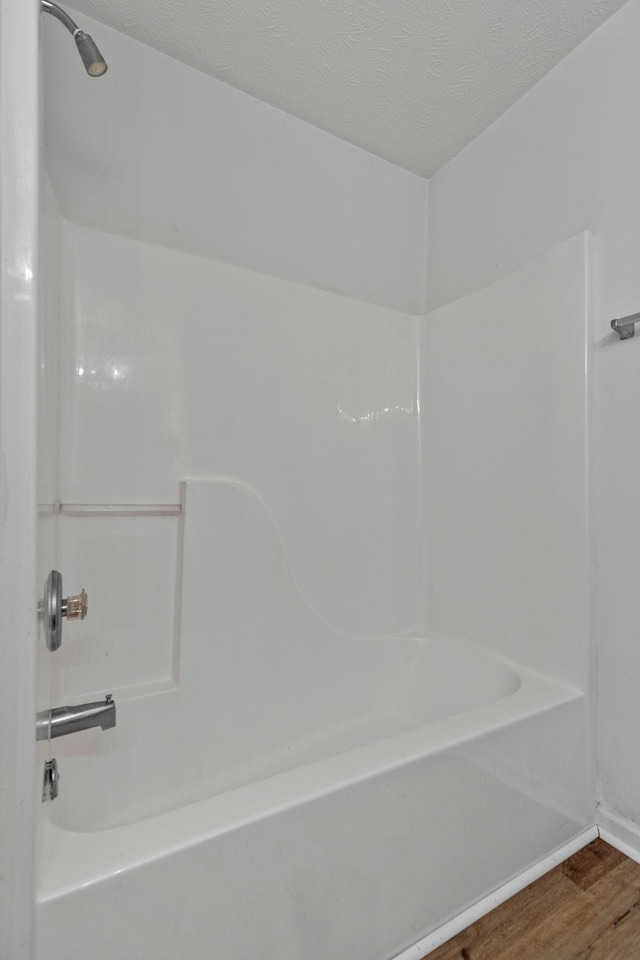 bathroom featuring shower / bath combination and wood finished floors