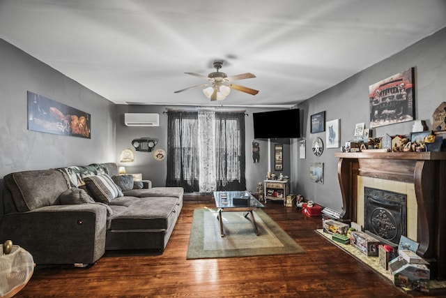 living room with wood finished floors, ceiling fan, a fireplace, and a wall mounted AC