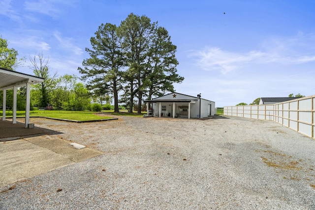 view of yard with an outdoor structure and fence