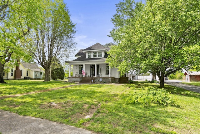 view of front of house with a porch and a front yard