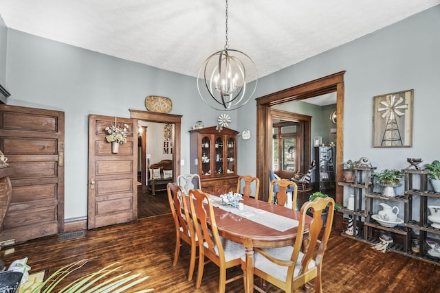 dining space with a chandelier and dark wood-type flooring