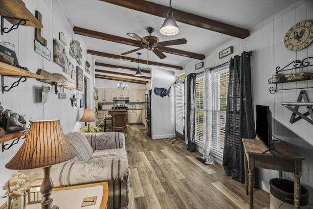 interior space with baseboards, beamed ceiling, dark wood-style floors, and ceiling fan with notable chandelier