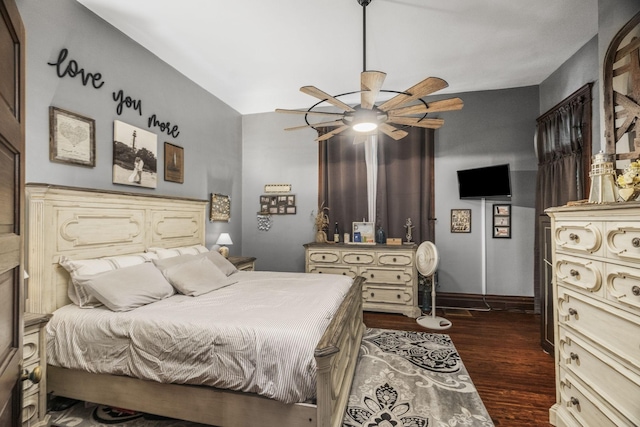 bedroom featuring dark wood-style flooring, ceiling fan, and baseboards