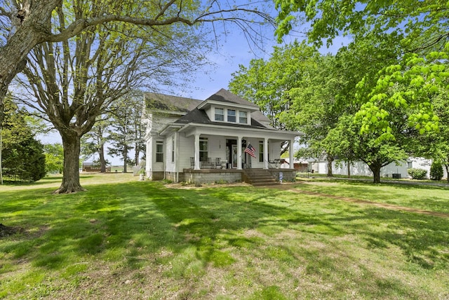 view of front of home with covered porch and a front yard