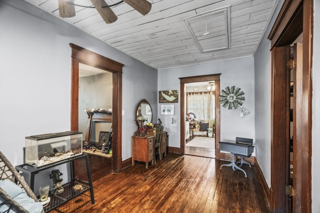 hall featuring hardwood / wood-style flooring and baseboards