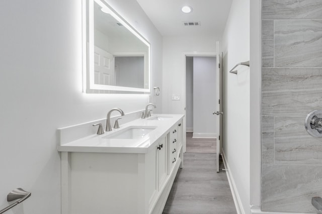 117 Apollo Ct W, Antioch, TN 37013 - bathroom featuring double vanity, visible vents, a sink, and wood finished floors