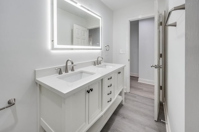117 Apollo Ct W, Antioch, TN 37013 - bathroom with double vanity, baseboards, a sink, and wood finished floors