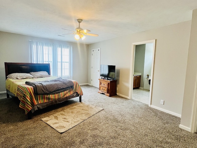 bedroom with baseboards, ensuite bathroom, a ceiling fan, and light colored carpet