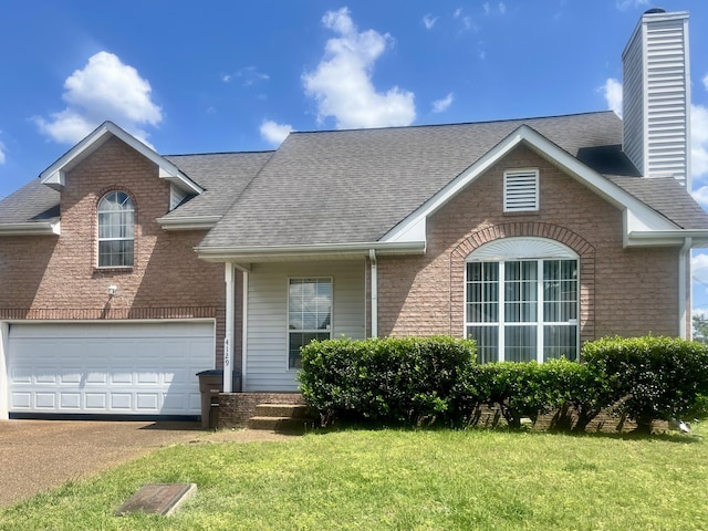 4129 Pleasant Colony Dr, Antioch, TN 37013 - traditional home with brick siding, a shingled roof, a front yard, a chimney, and a garage