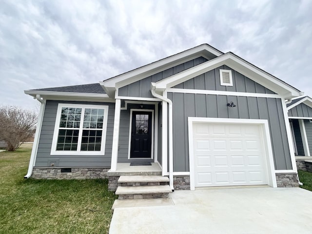 510 Lautzenheiser Pl, Monteagle, TN 37356 - view of front facade featuring board and batten siding, a garage, driveway, stone siding, and a front lawn