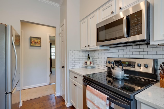 231 Westchase Dr, Nashville, TN 37205 - kitchen featuring white cabinetry, stainless steel appliances, ornamental molding, and decorative backsplash