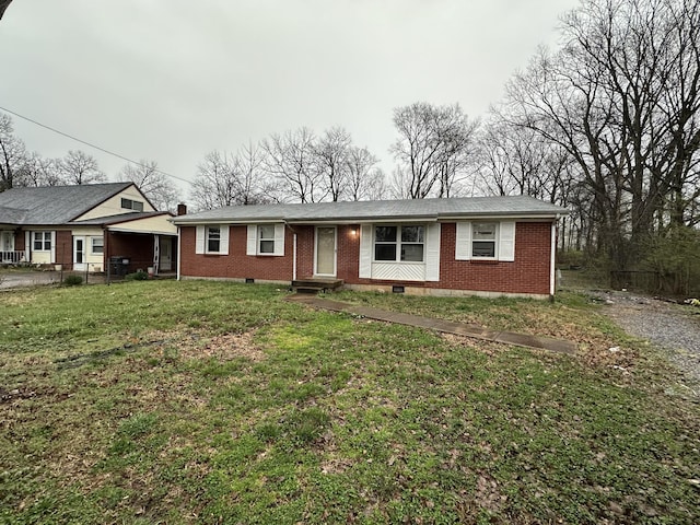 ranch-style house with brick siding, fence, entry steps, and a front lawn