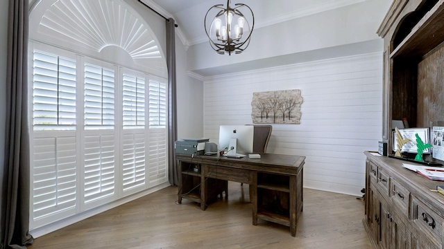 home office with crown molding, wooden walls, a notable chandelier, and wood finished floors