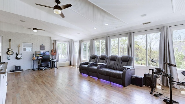living room with visible vents, ceiling fan, light wood finished floors, and vaulted ceiling