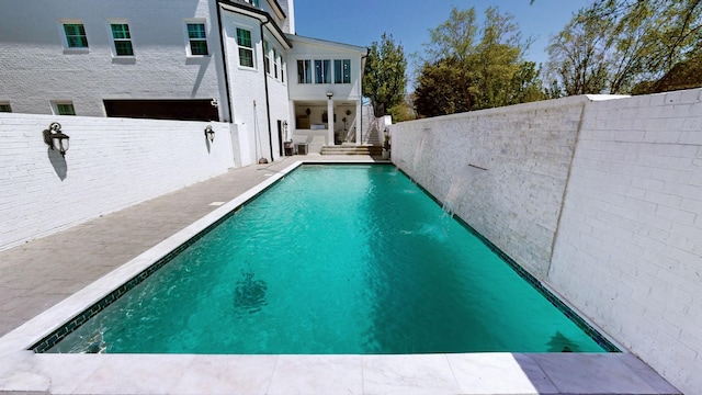 view of swimming pool with a patio, a fenced backyard, a fenced in pool, and stairs