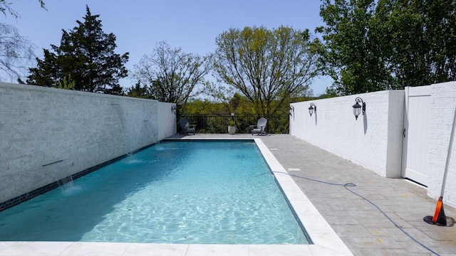 view of pool with a fenced in pool, a patio area, and a fenced backyard