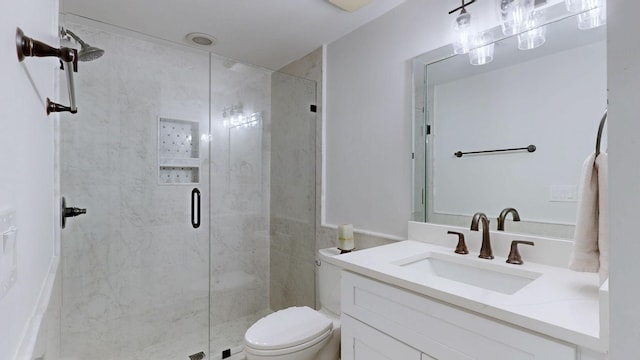 full bathroom featuring a stall shower, toilet, and vanity