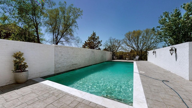 view of pool with a fenced in pool, a fenced backyard, and a patio area