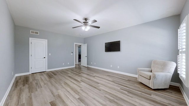 unfurnished room featuring visible vents, a ceiling fan, light wood finished floors, and baseboards