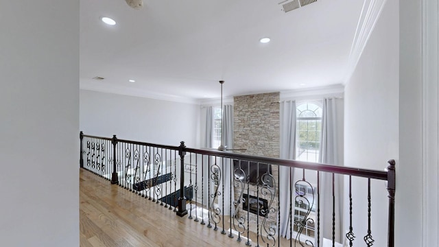 hall featuring visible vents, wood finished floors, crown molding, and recessed lighting