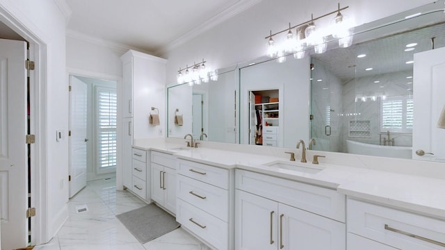 bathroom featuring a stall shower, marble finish floor, ornamental molding, and a sink