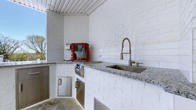 view of patio with a sink and an outdoor kitchen