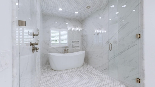 bathroom with recessed lighting, a marble finish shower, tile walls, and a freestanding tub