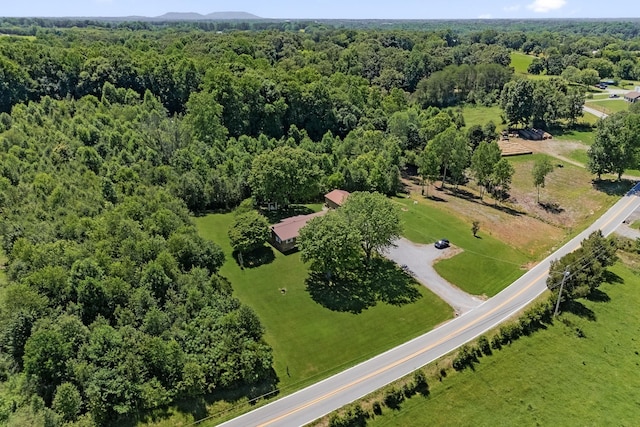birds eye view of property featuring a view of trees