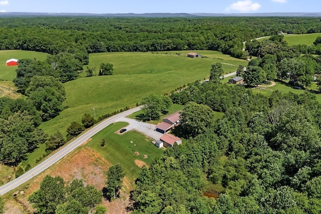 birds eye view of property featuring a forest view