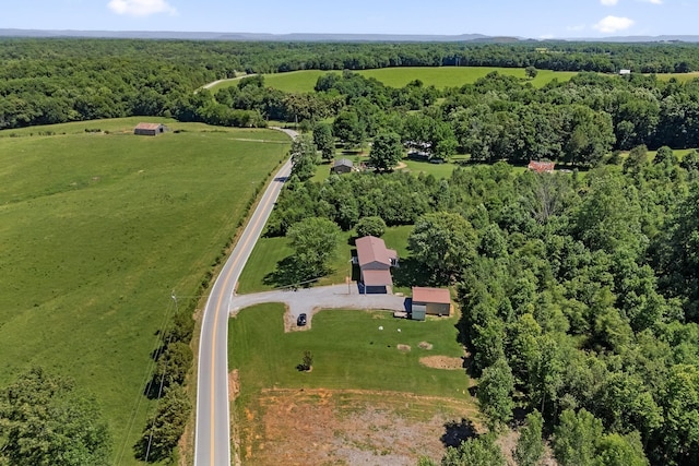 birds eye view of property featuring a forest view