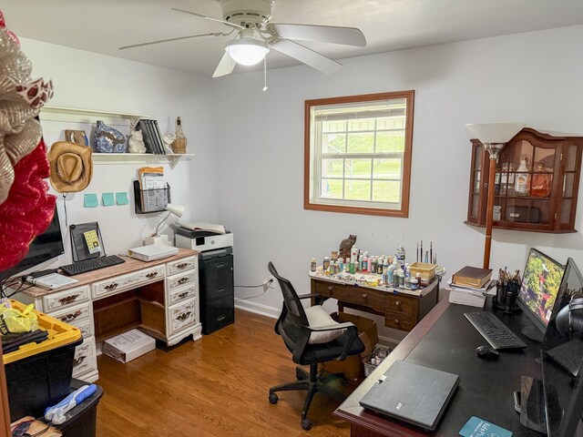 home office with wood finished floors and a ceiling fan