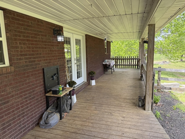 wooden deck with covered porch and french doors