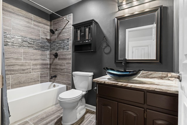 full bathroom with vanity, toilet, baseboards, shower / bath combination, and wood finished floors