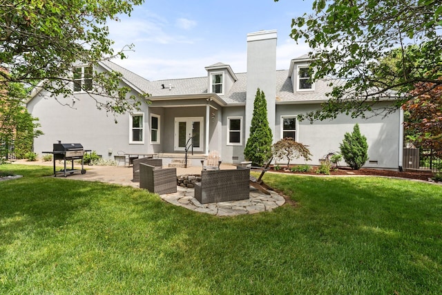 rear view of property with a patio, a lawn, stucco siding, and french doors