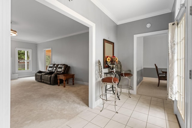 hall featuring crown molding, baseboards, and light carpet