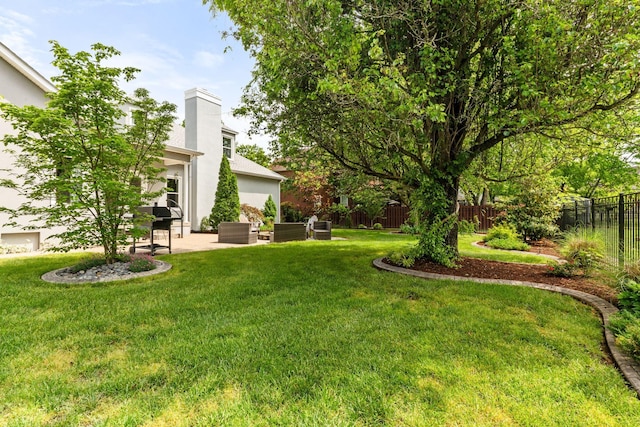 view of yard featuring an outdoor living space, a fenced backyard, and a patio area