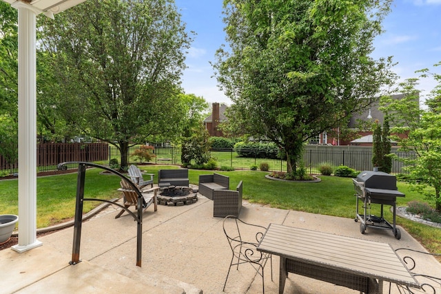 view of patio / terrace featuring a fenced backyard, outdoor dining area, a grill, and a fire pit