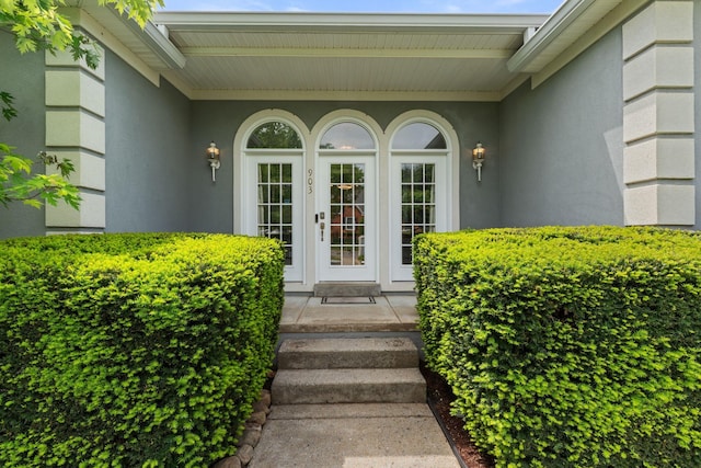 entrance to property featuring stucco siding