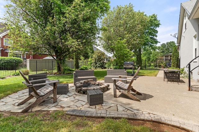 view of patio featuring an outdoor fire pit and fence