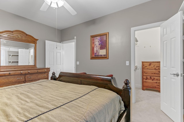 bedroom with light colored carpet and a ceiling fan