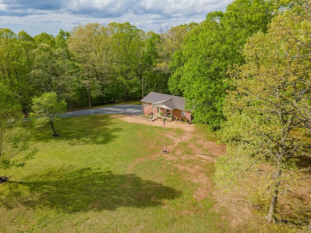 drone / aerial view featuring a view of trees