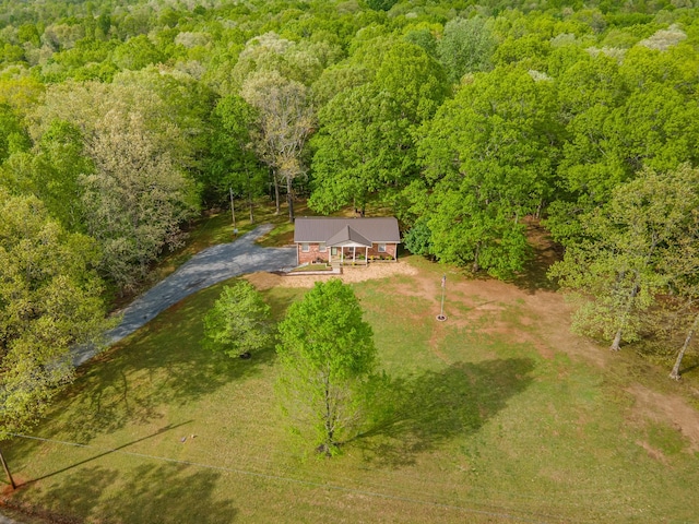 birds eye view of property featuring a view of trees