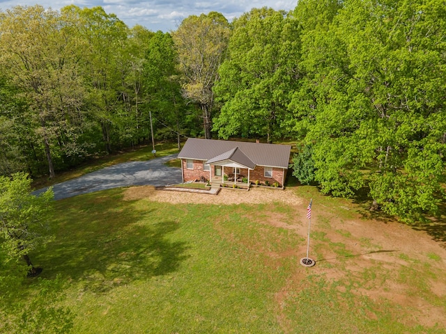 aerial view featuring a wooded view