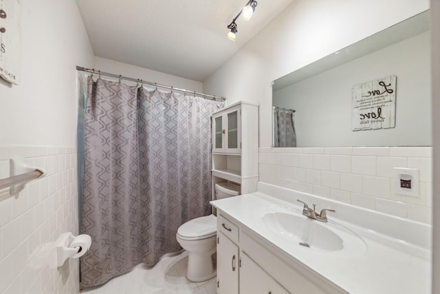 bathroom featuring vanity, tile patterned flooring, toilet, tile walls, and a shower with curtain
