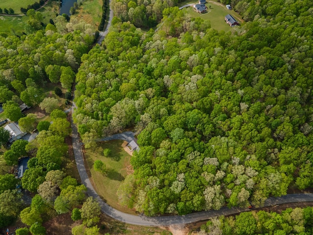 drone / aerial view featuring a wooded view
