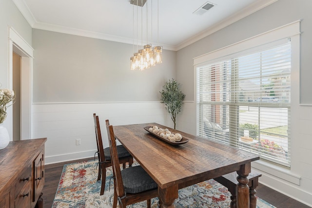 dining area with a healthy amount of sunlight, ornamental molding, dark wood-style floors, and visible vents