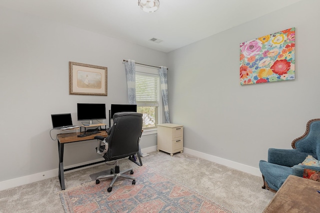 office featuring baseboards, light carpet, and visible vents
