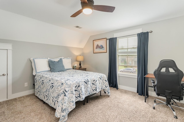 bedroom with a ceiling fan, visible vents, light carpet, and vaulted ceiling