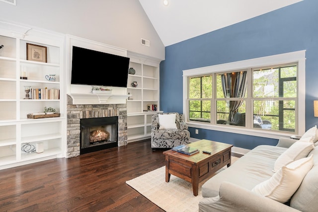 living room featuring high vaulted ceiling, a stone fireplace, wood finished floors, and visible vents
